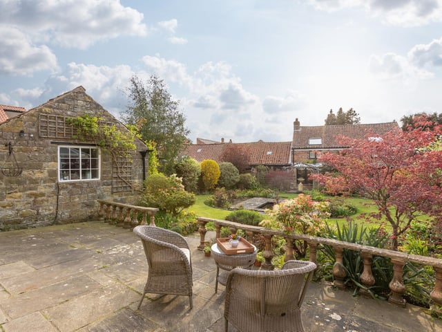 A pleasant patio area overlooks the garden.