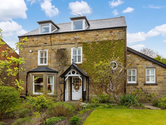 A close-up view of the front of Farmleigh, with its bay window and entry porch.