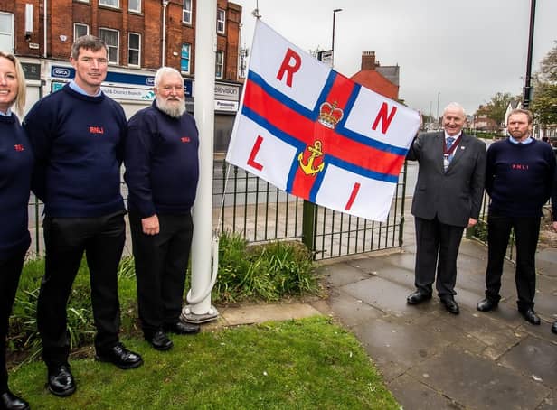 Mike Heslop-Mullens helps raise the RNLI flag for the MayDay Appeal. Photo courtesy of Mike Milner/RNLI