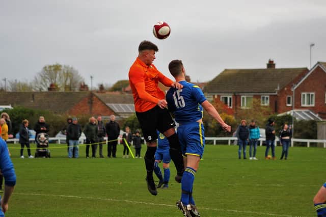 Ryan Link, orange kit, scored the crucial third goal for Edgehill in the Harbour Cup final against Filey Town