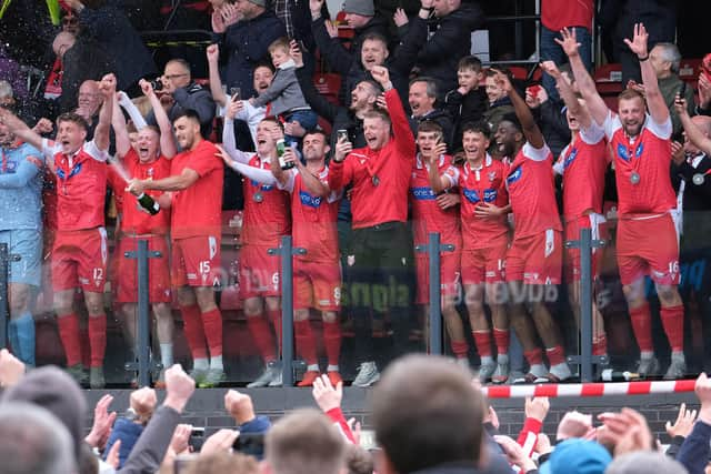 GOING UP: Scarborough players celebrate their promotion to National League North after a play-off victory over Warrington Town. Picture: Richard Ponter