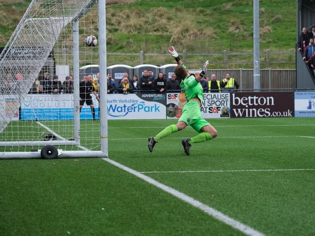 Michael Coulson's shot puts Scarborough Athletic 1-0 ahead in the first half against Warrington Town despite a dive from Town keeper Dan Atherton