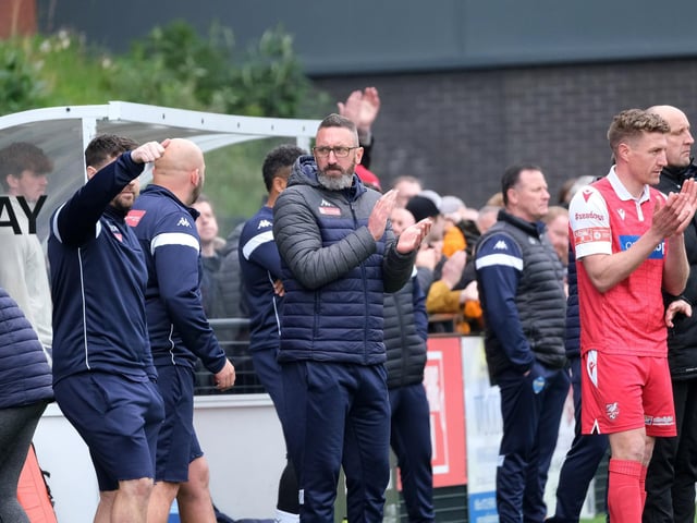 The Boro bench, including manager Jonathan Greening, applaud Ryan Watson's efforts as the midfielder is replaced by Simon Heslop, left