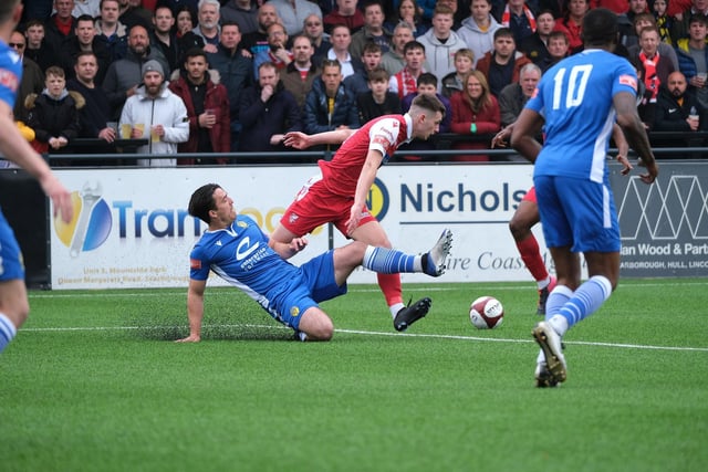 Warrington Town's Matt Regan looks to nick the ball away from Boro's Luca Colville