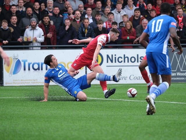 Warrington Town's Matt Regan looks to nick the ball away from Boro's Luca Colville