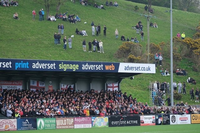 Boro fans watch from the fields behind the Flamingo Land Stadium
