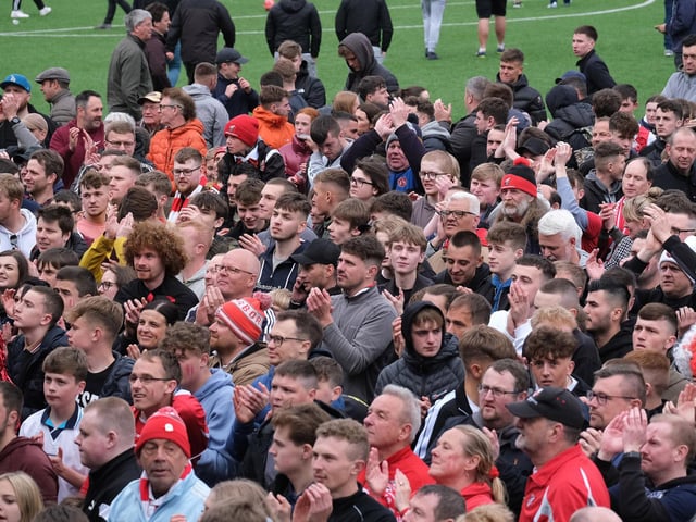 The jubilant Scarborough Athletic fans watch the trophy presentation after the final whistle