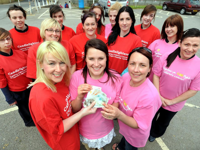 Yorkshire Coast College tutor Lisa Grattan, front, left, presents a cheque to Lori-Suzanne Kellett, centre, and Jackie Critchett, right, from Candlelighters, watched by students who took part in the sponsored walk.