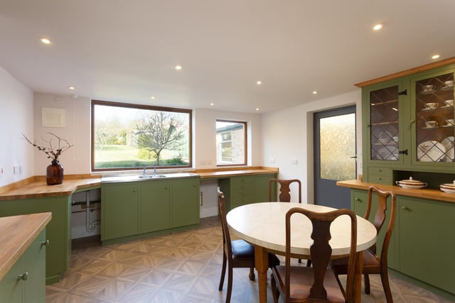 The roomy dining kitchen with picture window showing the garden.