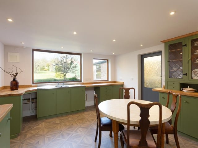 The roomy dining kitchen with picture window showing the garden.