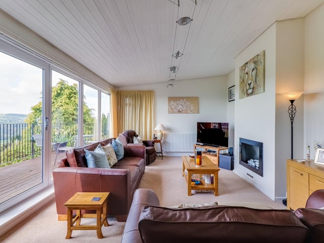 This lounge is filled with natural light and has access to a wide balcony feature outside.