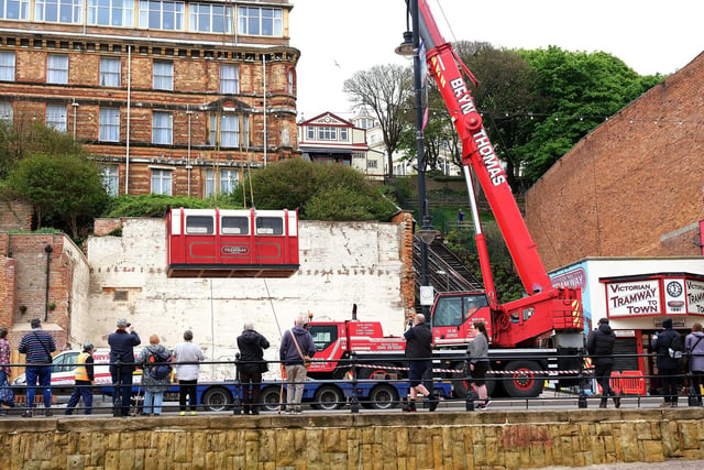 A 50-tonne crane was used to hoist the carriages back onto the tracks.