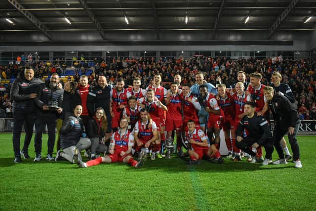 Boro players and staff line up with the cup