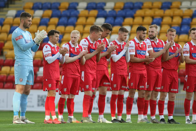 Boro players observe the minute's applause in tribute to former Scarborough FC striker Neil Campbell