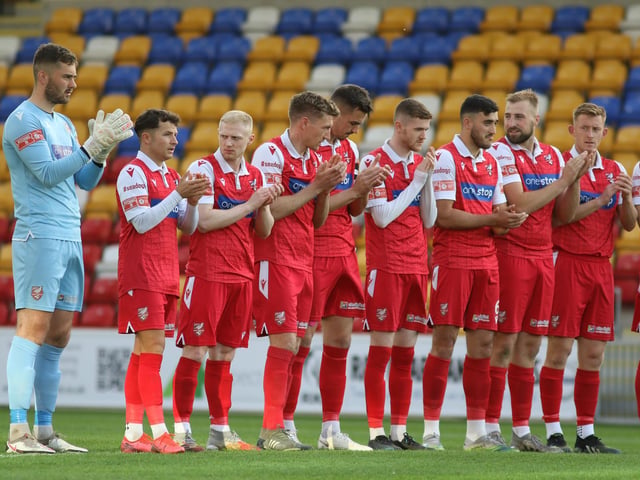 Boro players observe the minute's applause in tribute to former Scarborough FC striker Neil Campbell