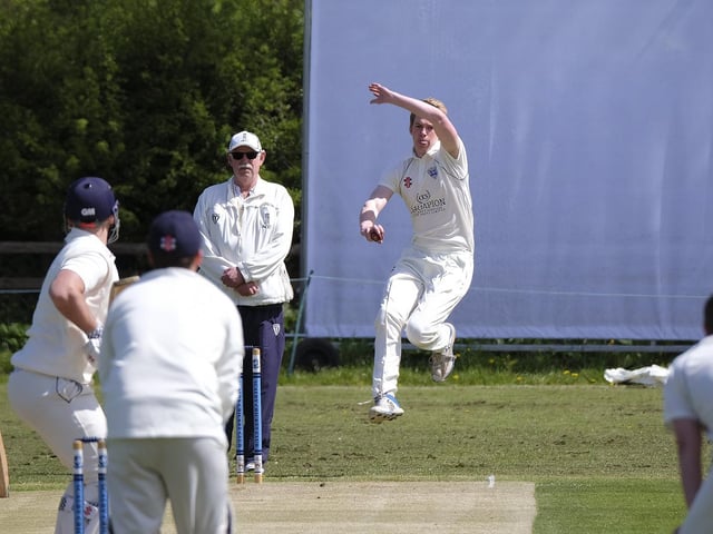 Callum Simpson in bowling action