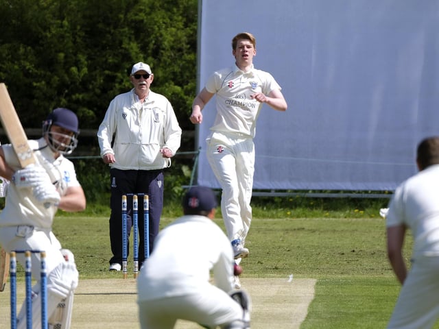 The batsman and bowler look to see where the ball has ended up