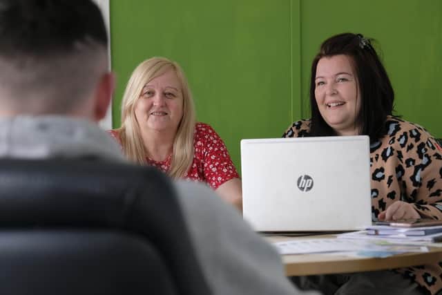 Anne Unsworth and Tiff Wilkey chat to a young person in the office.