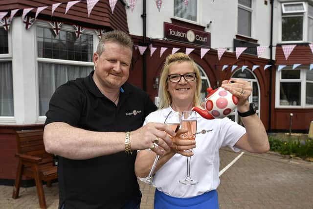 Angela and James Rusden, owners of The Toulson Court Bed and Breakfast, toast their first award win.
