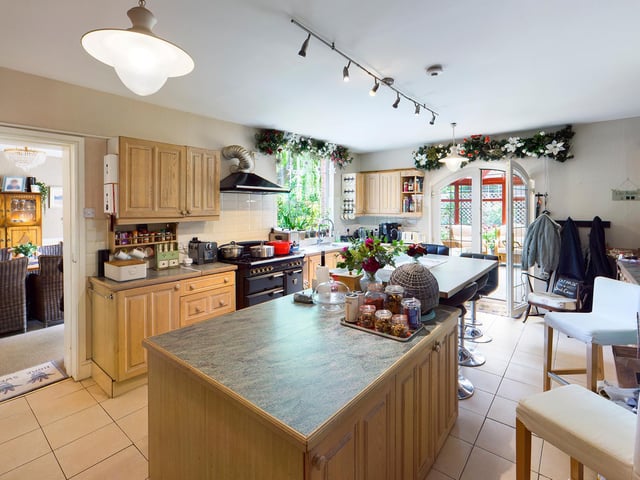 A central island is a feature of the kitchen, that oens through to the conservatory.