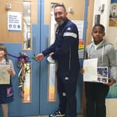 Children in the ward were invited to suggest a new name and draw a picture. Phoebe (age 6) and David (age 11) came up with the winning name - The Rainbow Ward. The youngsters are pictured with Scarborough Athletic manager Jonathan Greening as he cuts the ribbon to officially open the ward.