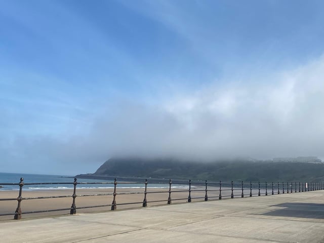 A sea fret descends over the headland.