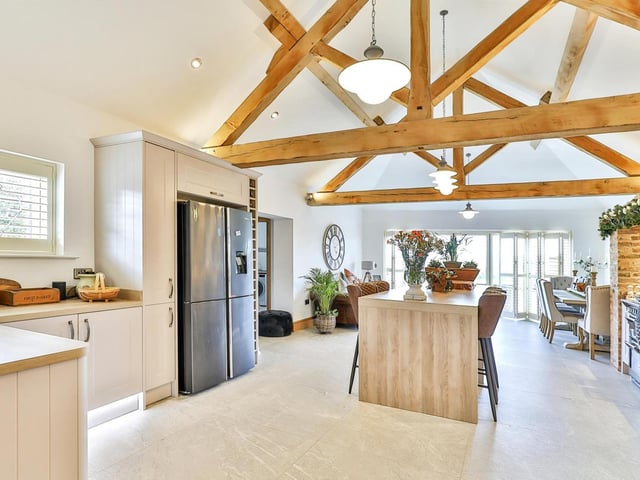 A central island with breakfast bar is one feature of the well equipped kitchen area.