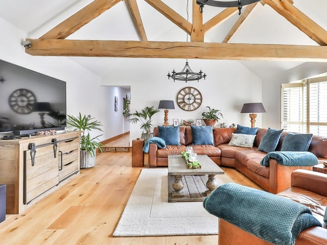A spacious yet cosy and comfortable lounge has doors leading outside.