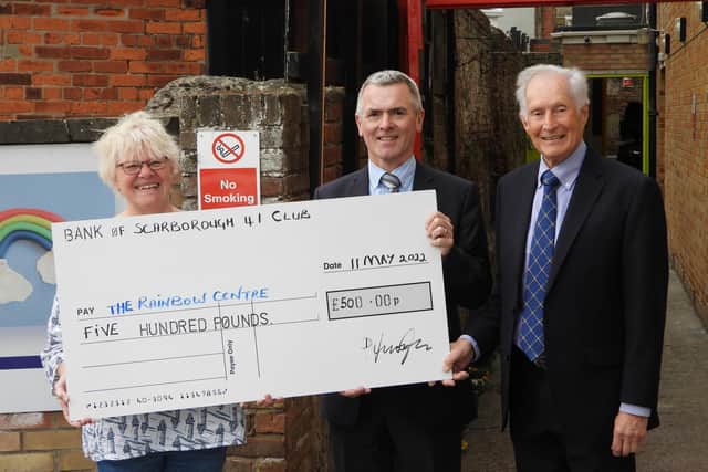 David Ascough, Scarborough 41 Club Chairman handing over the cheque to Trish Kinsella, Manager and John Trebble, Trustee and volunteer of The Rainbow Centre.