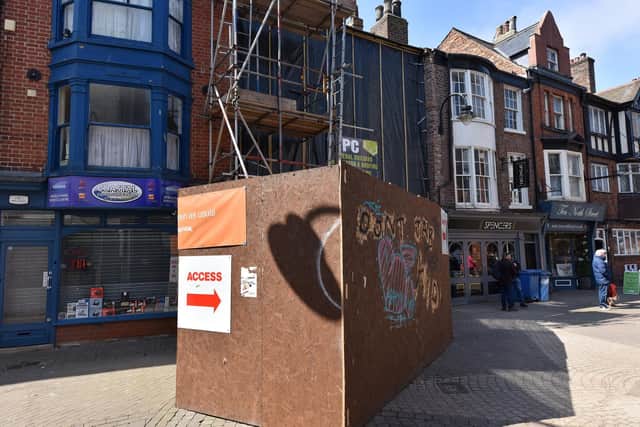 A hoarding was erected last summer over fears the building could collapse into the street, and remains as construction work continues.