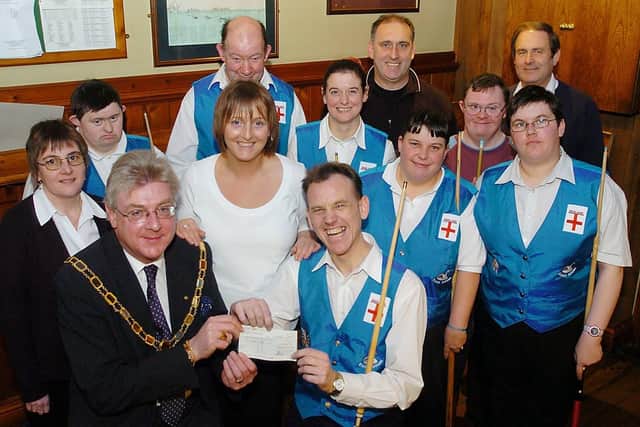 Bridlington Mayor Richard Harrap presents a £500 cheque from the town council to the Bridlington Special Pool Support Group’s captain David Pilmoor at The Seabirds pub on Fortyfoot in 2005. Photo by Paul Atkinson. (PA0504-12a)