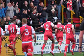 Scarborough Athletic skipper Michael Coulson, pictured celebrating his goal in the play-off final win against Warrington, extends stay