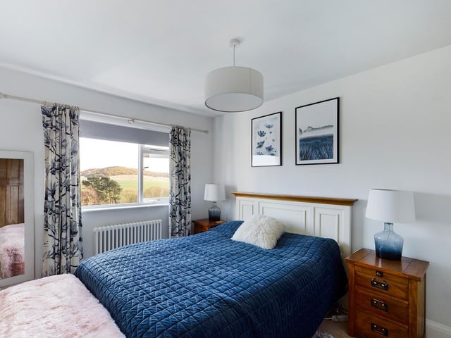 The scenic outlook enjoyed from many rooms can be seen through this bedroom window.