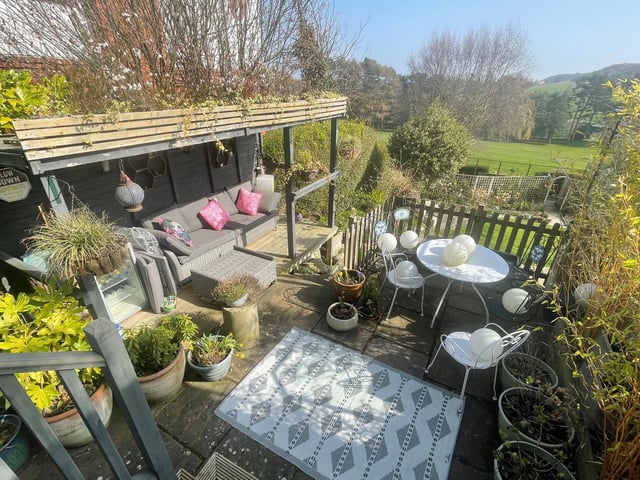 Steps lead down to the delightful garden and its outdoor spaces.