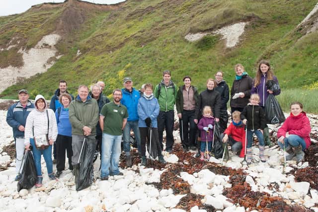 This photograph shows a group of volunteers during a Yorkshire Wildlife Trust Beach Clean at South Landing, Flamborough, in 2015. Do you recognise the people in the picture? (nbfp-msh1524y882)