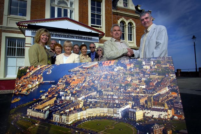 Mike and Trish Shaw present an aerial photograph of Whitby to the Friends of the Whitby Pavilion.