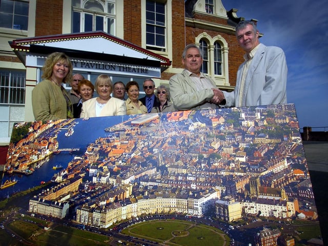 Mike and Trish Shaw present an aerial photograph of Whitby to the Friends of the Whitby Pavilion.