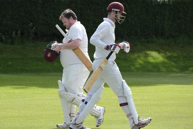 Staxton batsman Andy Dove, left, is dismissed, and is passed by incoming batsman Ryan Hargreaves