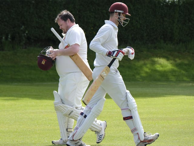Staxton batsman Andy Dove, left, is dismissed, and is passed by incoming batsman Ryan Hargreaves