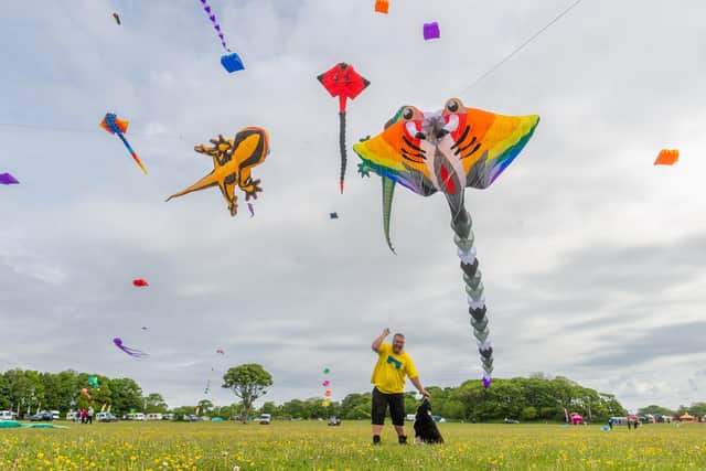 Andrew Beattie, a member of the Northern Kite Group, prepares his kites for the day along with his dog Kate. Photo by James Hardisty