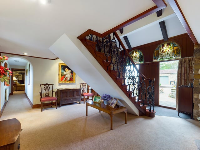 The feature staircase within the hallway leads up to a gallery landing.