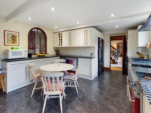 A modern kitchen with extensive fitted units and appliances.
