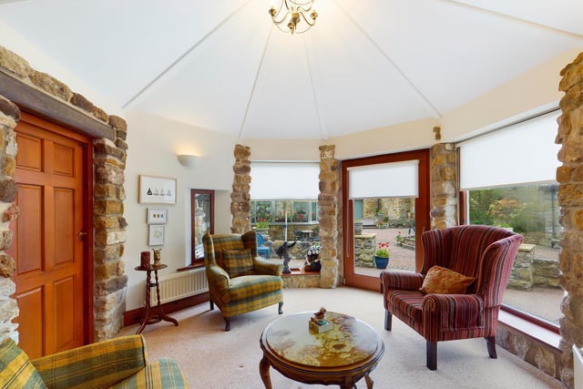 There's versatile space in rooms such as this one, with its unusual shape, large windows and open stonework.