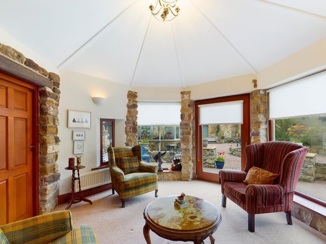 There's versatile space in rooms such as this one, with its unusual shape, large windows and open stonework.