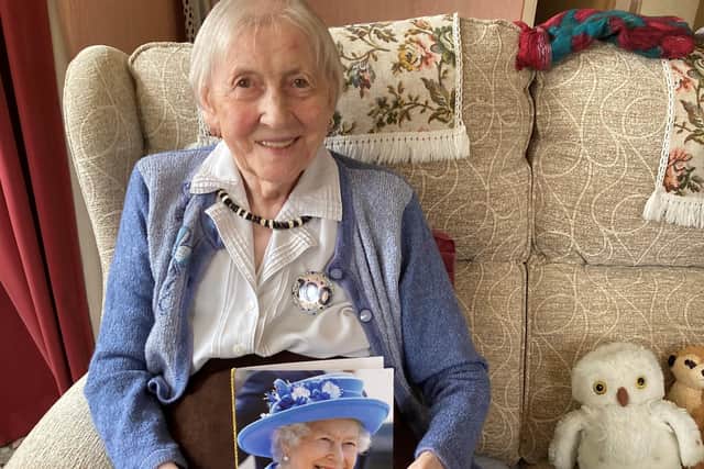 Marion Foster is pictured with her card from The Queen.