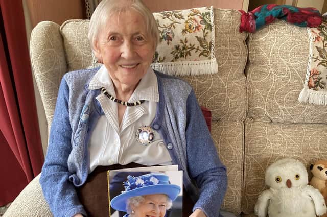 Marion Foster is pictured with her card from The Queen.