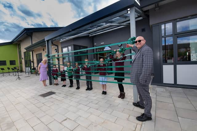 Headteacher Vicki Logan and Chair of Governors Pete Bowdidge-Harling with pupils performing Overdale Primary School’s official opening.