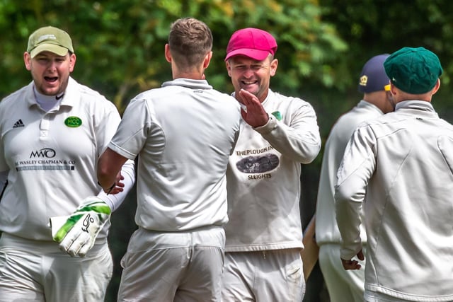 Mulgrave's Andy Raw is congratulated for his run-out of Toby Jones