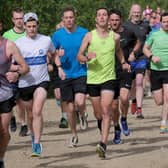Scarborough Athletic Club's Daniel Bateson, lime vest, wins at North Yorkshire Water Park parkrun