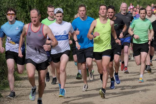 Scarborough Athletic Club's Daniel Bateson, lime vest, wins at North Yorkshire Water Park parkrun